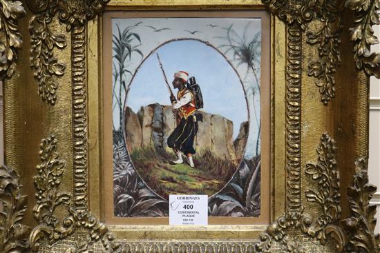 A 19th century Continental porcelain plaque painted with a Moroccan soldier, housed in an ornate gilt gesso frame, plaque 20 x 15cm